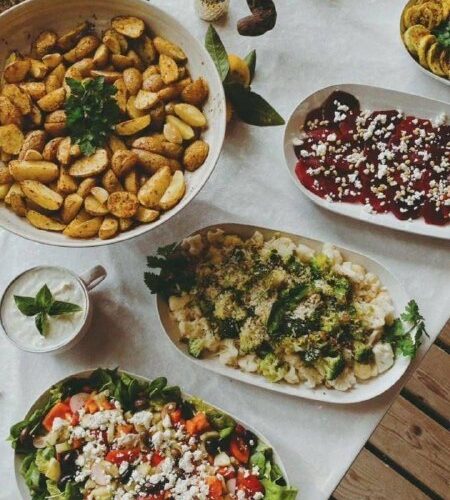 Традиционные блюда Черногории на праздничном столе: картофель, салаты и фрукты на мероприятиях в Черногории.